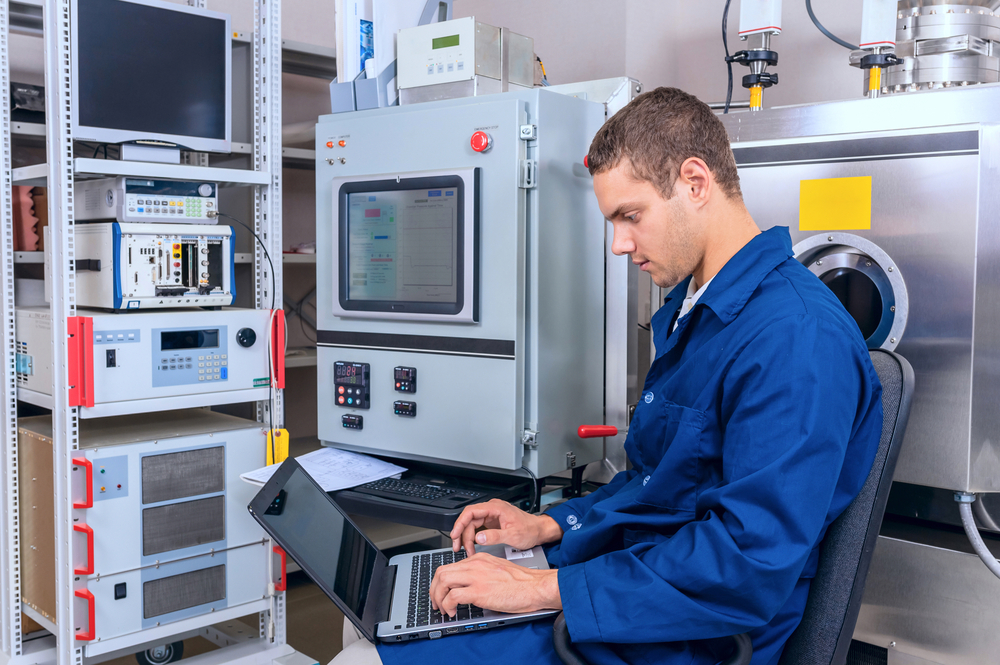 Young engineer working with a laptop working in a scientific laboratory